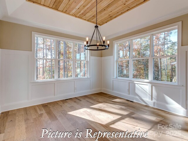 3439 Stags Leap Way, York, SC 29745 - unfurnished dining area featuring a decorative wall, wood ceiling, light wood-style flooring, a chandelier, and wainscoting