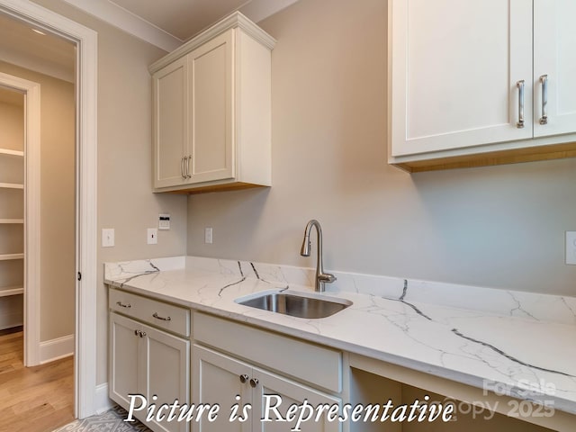 3439 Stags Leap Way, York, SC 29745 - kitchen featuring a sink, light wood finished floors, light stone countertops, and white cabinets