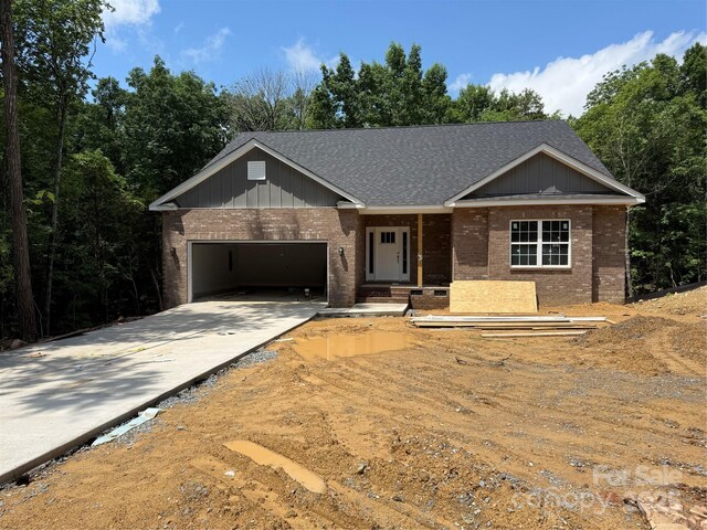2924 Noritake Trl Unit 67, Albemarle, NC 28001 - view of front of property featuring brick siding, a garage, driveway, and a shingled roof