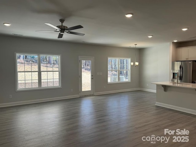 2924 Noritake Trl Unit 67, Albemarle, NC 28001 - unfurnished living room with a chandelier, recessed lighting, baseboards, ceiling fan, and dark wood-type flooring