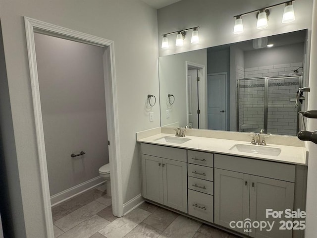 2924 Noritake Trl Unit 67, Albemarle, NC 28001 - bathroom featuring a stall shower, toilet, double vanity, and baseboards