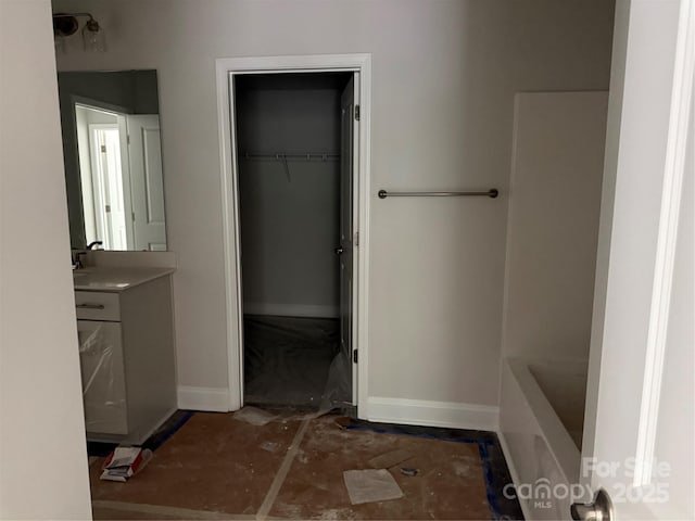 2924 Noritake Trl Unit 67, Albemarle, NC 28001 - full bathroom featuring baseboards, vanity, a walk in closet, and a tub