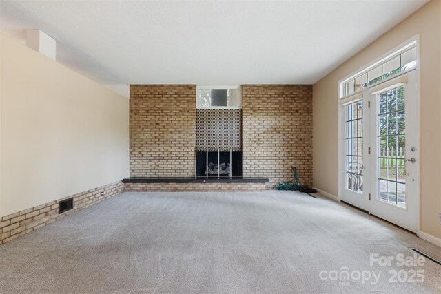 467 16th Ave NW, Hickory, NC 28601 - unfurnished living room with carpet, a brick fireplace, and brick wall