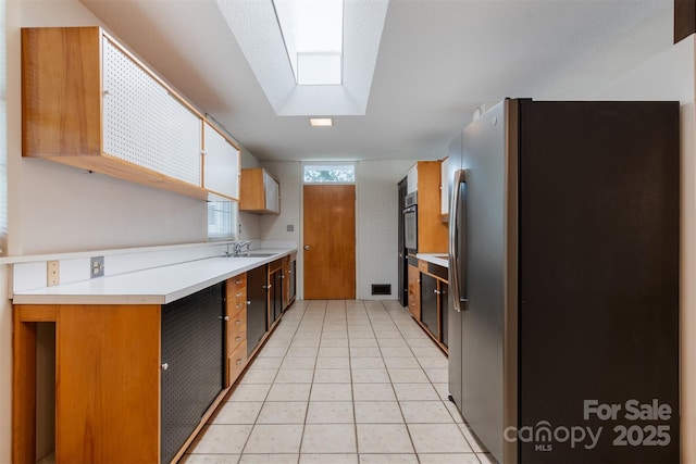 467 16th Ave NW, Hickory, NC 28601 - kitchen featuring stainless steel refrigerator with ice dispenser, a sink, light countertops, and light tile patterned floors