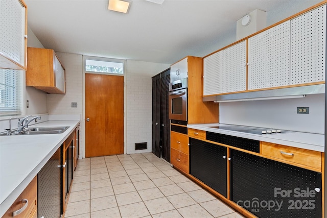 467 16th Ave NW, Hickory, NC 28601 - kitchen with oven, black electric stovetop, light countertops, a sink, and light tile patterned flooring