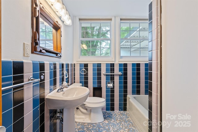 467 16th Ave NW, Hickory, NC 28601 - full bathroom featuring tile walls, toilet, tile patterned floors, a tub to relax in, and wainscoting
