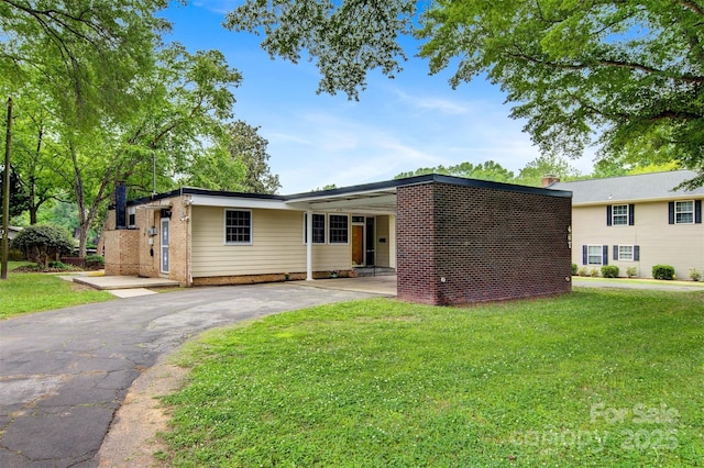 467 16th Ave NW, Hickory, NC 28601 - view of front of house with asphalt driveway, a front lawn, and a chimney