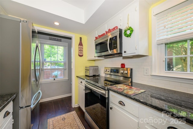 9239 N Vicksburg Park Ct, Charlotte, NC 28210 - kitchen featuring appliances with stainless steel finishes, white cabinets, dark wood finished floors, baseboards, and tasteful backsplash