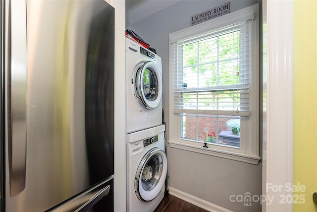 9239 N Vicksburg Park Ct, Charlotte, NC 28210 - washroom with stacked washer / dryer, dark wood-style floors, healthy amount of natural light, and baseboards