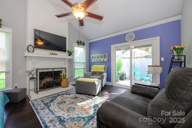 9239 N Vicksburg Park Ct, Charlotte, NC 28210 - living room with lofted ceiling, ceiling fan, a fireplace with raised hearth, dark wood-style floors, and ornamental molding