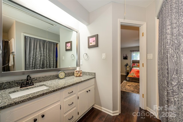 9239 N Vicksburg Park Ct, Charlotte, NC 28210 - full bathroom featuring wood finished floors, baseboards, vanity, and ensuite bathroom