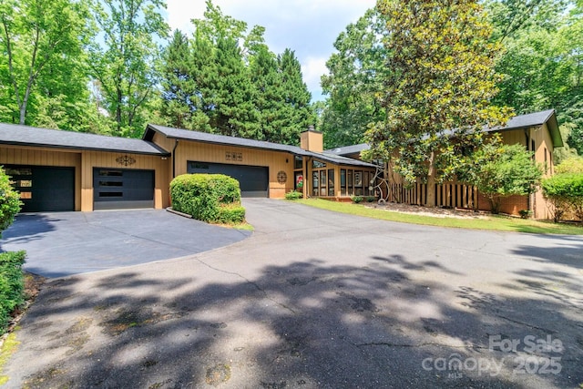 6119 Bittersweet Ln, Charlotte, NC 28270 - mid-century inspired home featuring asphalt driveway, a chimney, fence, and a garage
