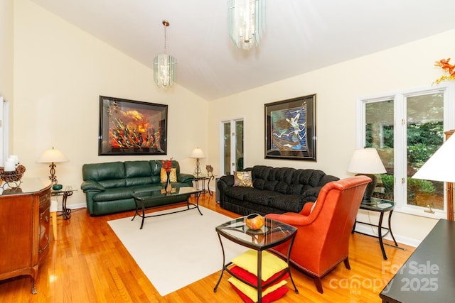 6119 Bittersweet Ln, Charlotte, NC 28270 - living room featuring wood finished floors, vaulted ceiling, and baseboards