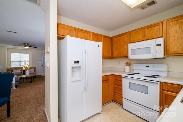 15042 Deshler Ct, Charlotte, NC 28273 - kitchen featuring white appliances, light countertops, open floor plan, ceiling fan, and brown cabinets