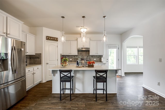 922 Bunker Trce, Rock Hill, SC 29730 - kitchen featuring stainless steel appliances, arched walkways, tasteful backsplash, and dark wood-style floors