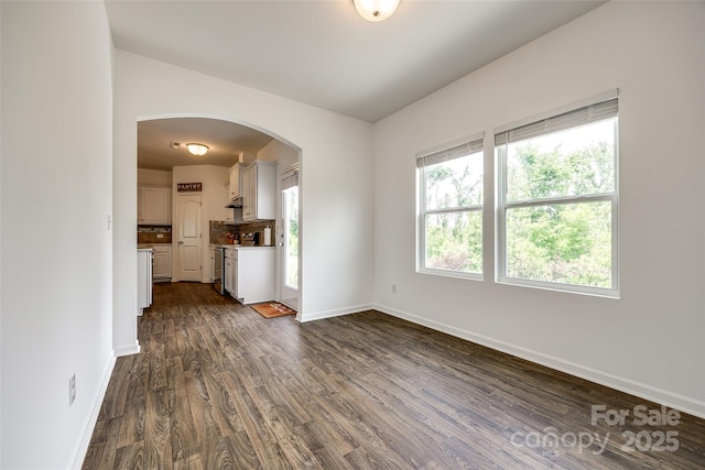 922 Bunker Trce, Rock Hill, SC 29730 - unfurnished living room with arched walkways, dark wood-type flooring, and baseboards