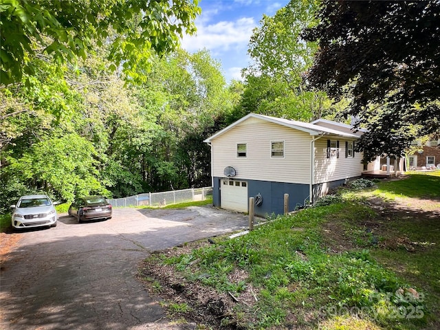 99 Boone St, Spruce Pine, NC 28777 - view of side of property with asphalt driveway and a garage