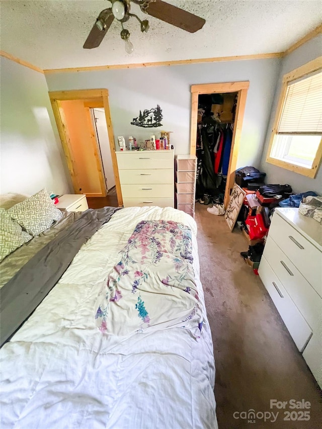99 Boone St, Spruce Pine, NC 28777 - bedroom with carpet flooring, a spacious closet, a closet, a textured ceiling, and ceiling fan
