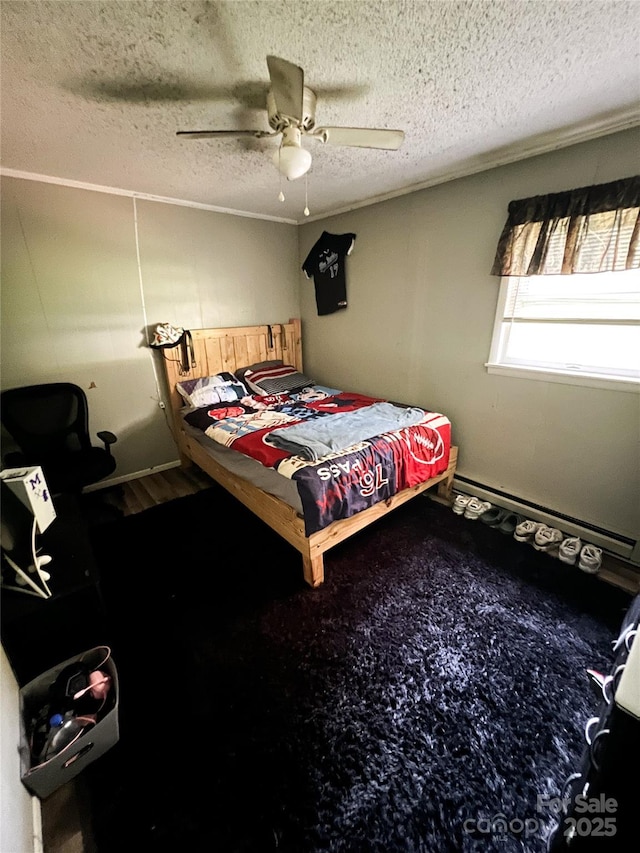 99 Boone St, Spruce Pine, NC 28777 - bedroom with baseboard heating, a textured ceiling, and a ceiling fan