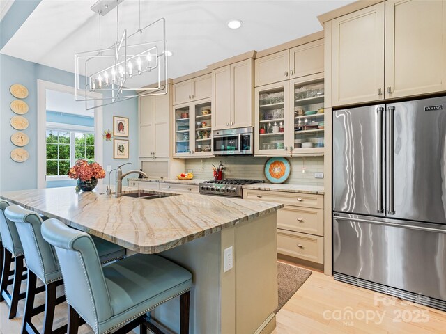 63 Chantilly Dr, Asheville, NC 28804 - kitchen with appliances with stainless steel finishes, a sink, a breakfast bar, recessed lighting, and tasteful backsplash