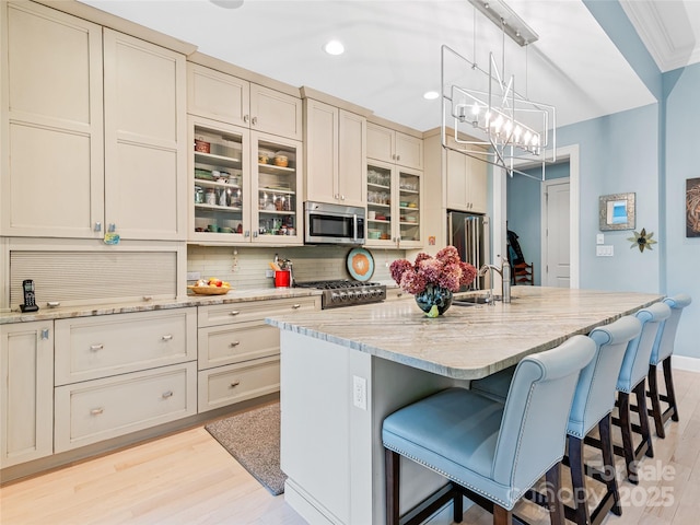 63 Chantilly Dr, Asheville, NC 28804 - kitchen featuring appliances with stainless steel finishes, light wood-type flooring, decorative backsplash, a breakfast bar, and recessed lighting