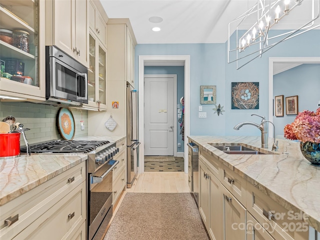 63 Chantilly Dr, Asheville, NC 28804 - kitchen with stainless steel appliances, a sink, recessed lighting, decorative backsplash, and glass insert cabinets