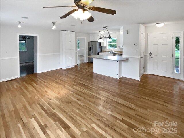 7308 Pleasant Hill Church Rd, Marshville, NC 28103 - unfurnished living room featuring a ceiling fan, light wood-style floors, and baseboards