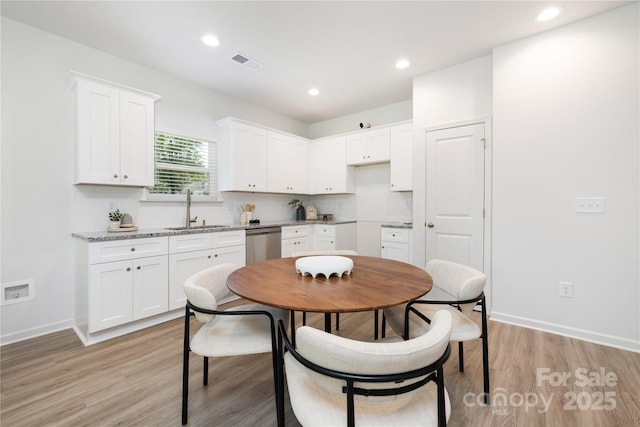 6 Bridge St, Lowell, NC 28098 - kitchen with a sink, stainless steel dishwasher, backsplash, light wood-type flooring, and recessed lighting
