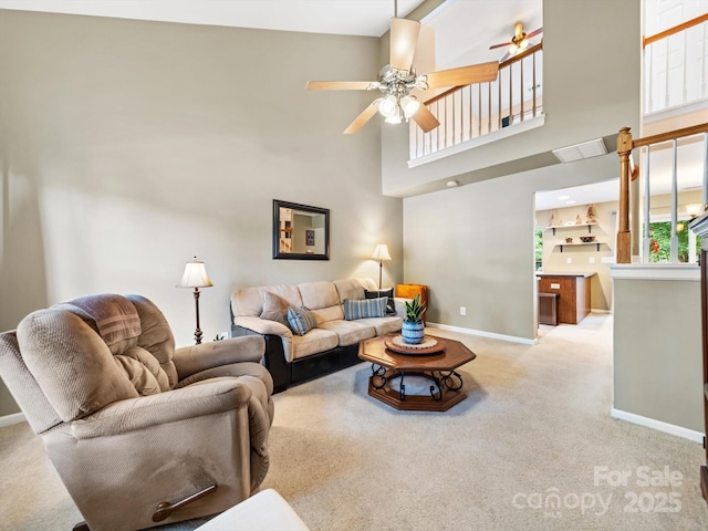3446 Broadwick St, Charlotte, NC 28213 - living room featuring baseboards, carpet floors, a ceiling fan, healthy amount of natural light, and a high ceiling