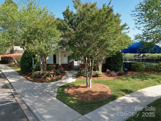 3446 Broadwick St, Charlotte, NC 28213 - view of property hidden behind natural elements featuring fence, brick siding, and a gate