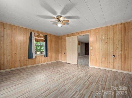 751 Ted Smith Rd, Rutherfordton, NC 28139 - spare room with wood finished floors, a ceiling fan, baseboards, and wood walls