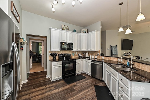 4018 Harmattan Dr, Denver, NC 28037 - kitchen with black appliances, a sink, a peninsula, dark wood finished floors, and decorative backsplash