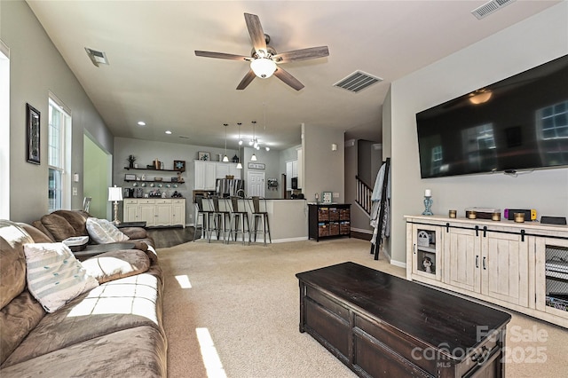 4018 Harmattan Dr, Denver, NC 28037 - living room with a ceiling fan, light colored carpet, stairs, recessed lighting, and baseboards