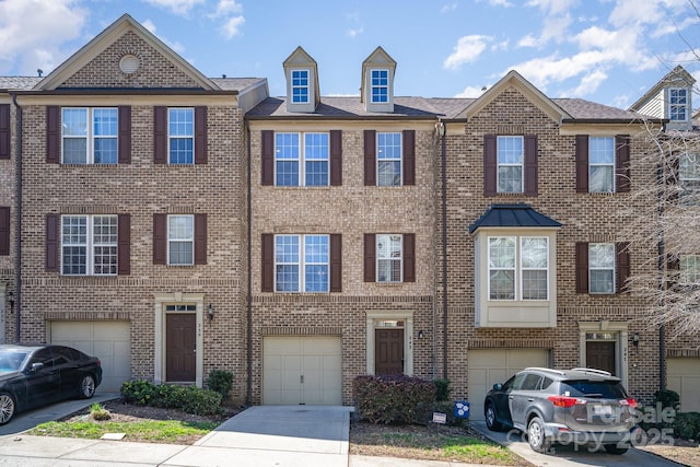 243 Lincoln St, Charlotte, NC 28203 - townhome / multi-family property featuring driveway, an attached garage, and brick siding