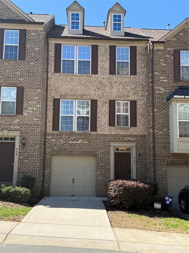 243 Lincoln St, Charlotte, NC 28203 - townhome / multi-family property with concrete driveway, a garage, and brick siding