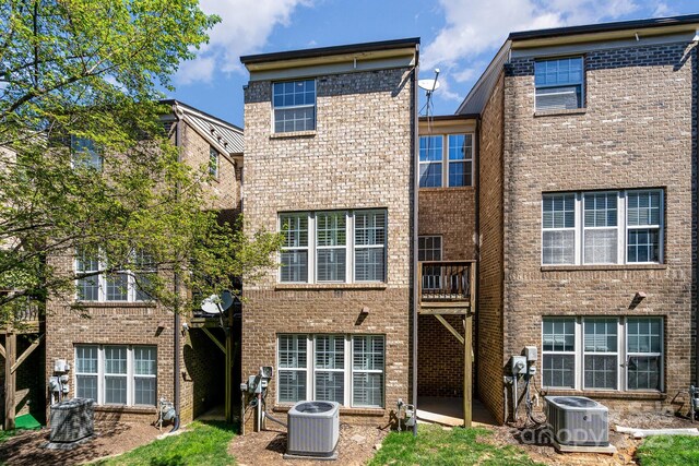 243 Lincoln St, Charlotte, NC 28203 - rear view of house featuring cooling unit and brick siding
