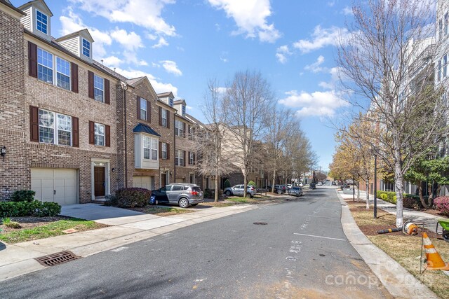 243 Lincoln St, Charlotte, NC 28203 - view of asphalt road with a residential view, sidewalks, and curbs