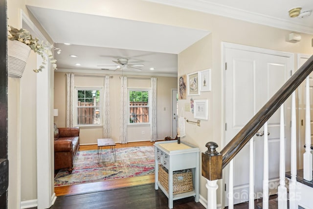 entryway with stairway, crown molding, dark wood-type flooring, a ceiling fan, and recessed lighting