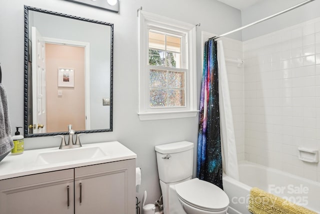 bathroom with toilet, shower / tub combo with curtain, and vanity