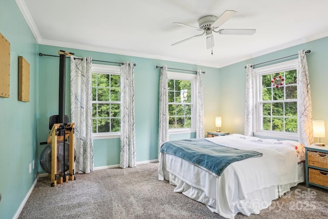 bedroom with ornamental molding, baseboards, carpet, and a ceiling fan