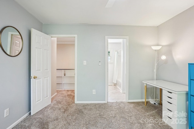 unfurnished bedroom with carpet, baseboards, and a ceiling fan