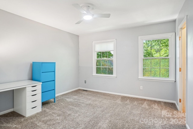 unfurnished bedroom with light carpet, baseboards, and ceiling fan