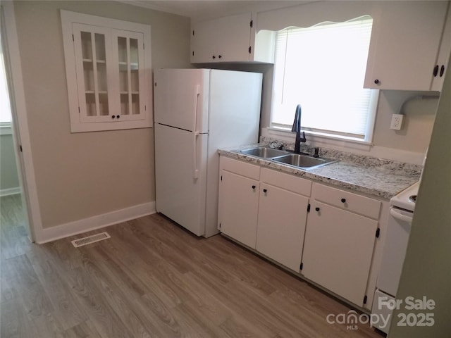 209 Barber Rd, Gastonia, NC 28056 - kitchen featuring freestanding refrigerator, a sink, white cabinets, and light countertops