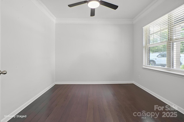 spare room with ceiling fan, ornamental molding, dark wood finished floors, and baseboards