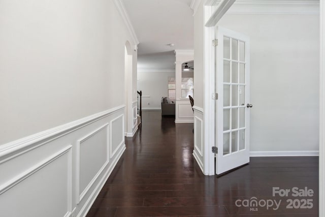 hallway with ornamental molding and dark wood-style floors