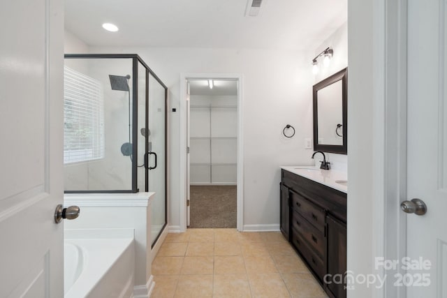full bathroom featuring a shower stall, a garden tub, double vanity, and tile patterned floors