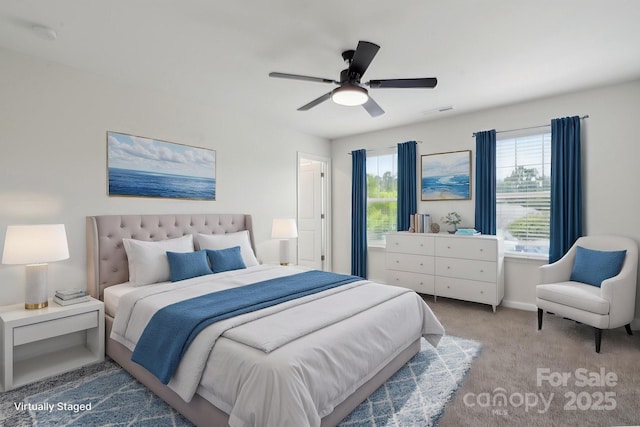 bedroom with multiple windows, carpet, and a ceiling fan