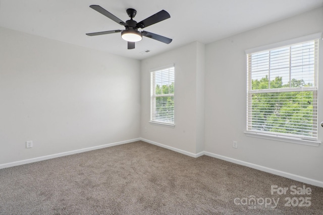 carpeted empty room with baseboards and ceiling fan