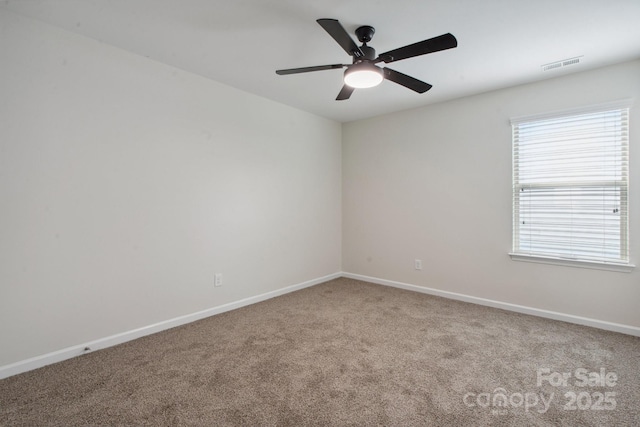 empty room with carpet flooring, baseboards, and ceiling fan