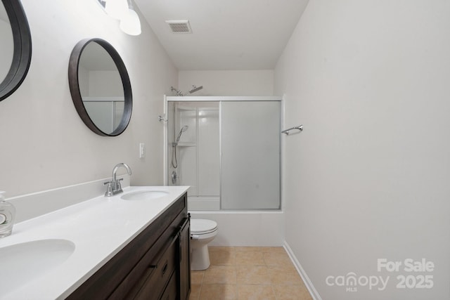 bathroom with toilet, tile patterned flooring, double vanity, and enclosed tub / shower combo